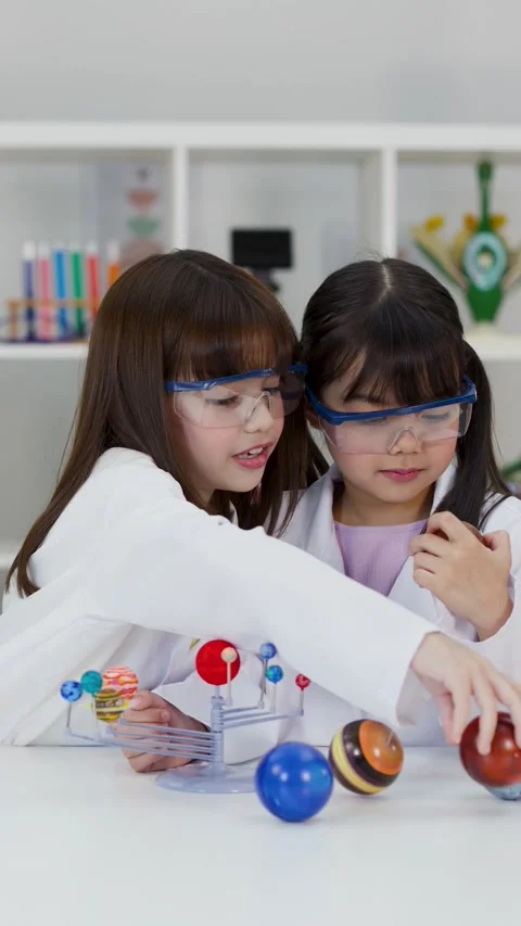 Elementary School Girls Studying Solar System Model in Science Lab Stock Footage 342313165