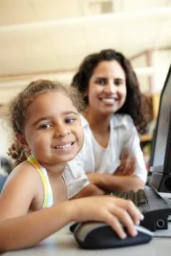 Elementary School Pupil With Teacher In Computer Class Stock Photos
