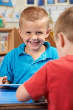 Elementary School Pupil Using Digital Tablet In Classroom Stock Photos