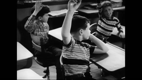 Elementary School Pupils Raise Hand To Answer Teachers Question In Classroom Stock Footage 157788289