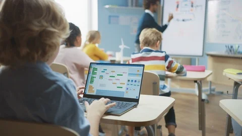 Elementary School Science Class: Little Boy Uses Laptop Programming Software Video stock 119056709