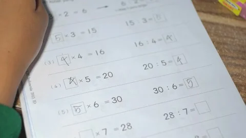 An elementary school student is doing math homework that is about multiplic.. Stock Footage 241998383