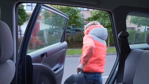 Elementary-school student goes to school. The boy out of the car and waving to Video stock 89221943