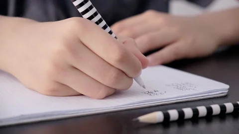Elementary school student hand writing mathematics homework tasks at home Stock Footage 127469841
