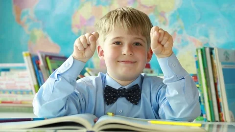  An elementary school student. Portrait of a cheerful schoolboy. The boy shows a Stock Footage 77747450