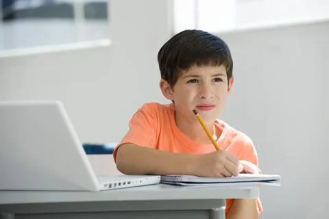Elementary school student taking notes in class Stock Photos