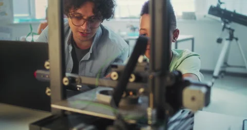 Elementary School Student Watching Printing Process on Automated 3D Printer on Stock Footage 311672836