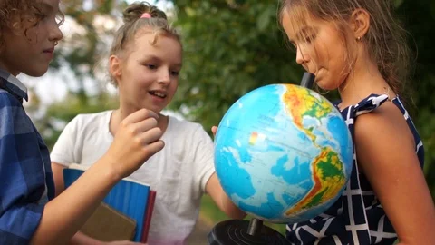 Elementary school student with world globe. Children communicate Stock Footage 113953458