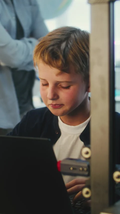 Elementary School Student Writing Code for Advanced 3D Printer on Laptop During Stock Footage 311808845