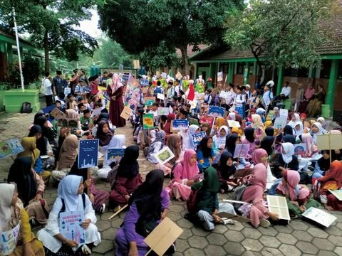 Elementary school students are gathering in the school yard Stock Photos