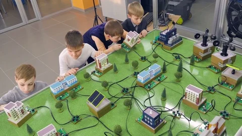 Elementary school students doing study alternative energy project on a city Stock Footage