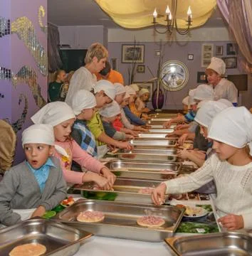 Elementary school students learn to cook pizza. Cooking classes Stock Photos