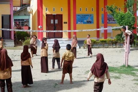 Elementary school students playing volleyball Stock Photos