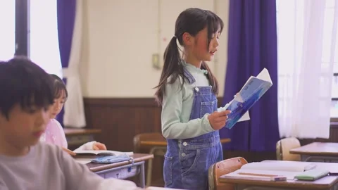Elementary School Students Reading Textbooks Aloud Stock Footage 332751134