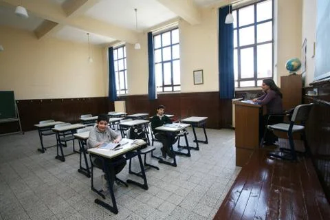 Elementary school students studying in classroom Stock Photos