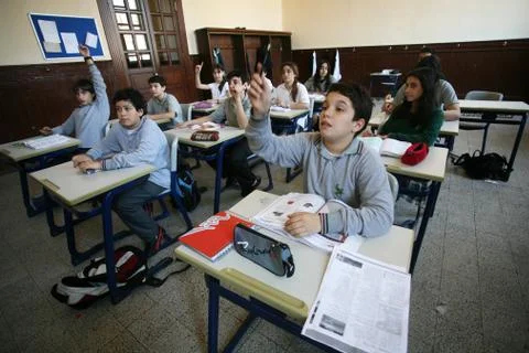 Elementary school students studying in classroom Stock Photos