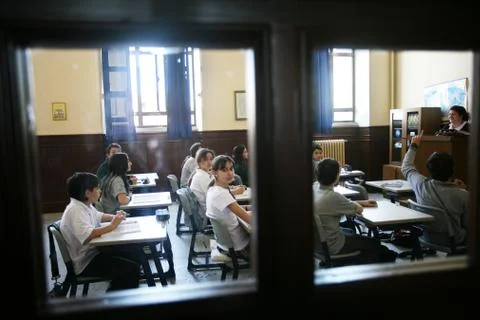 Elementary school students studying in classroom Stock Photos