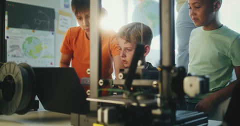 Elementary School Students Writing Code for Advanced 3D Printer on Laptop During Stock Footage 311675453