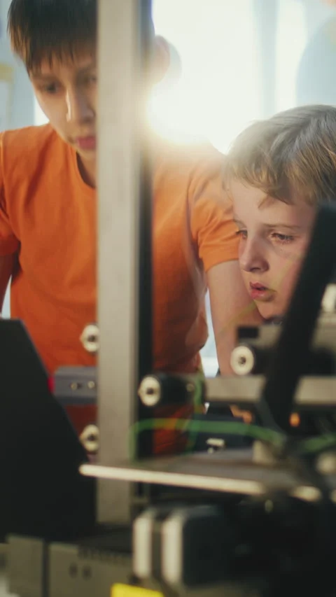 Elementary School Students Writing Code for Advanced 3D Printer on Laptop During Stock Footage 311807704