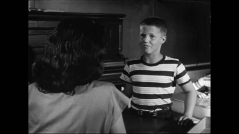 Elementary School Teacher Interacting With Smiling Schoolboy In Classroom Stock Footage 157788697