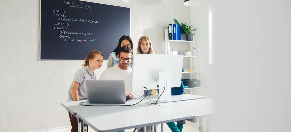 Elementary school teacher leading a coding lesson in a classroom, using a c.. 写真素材