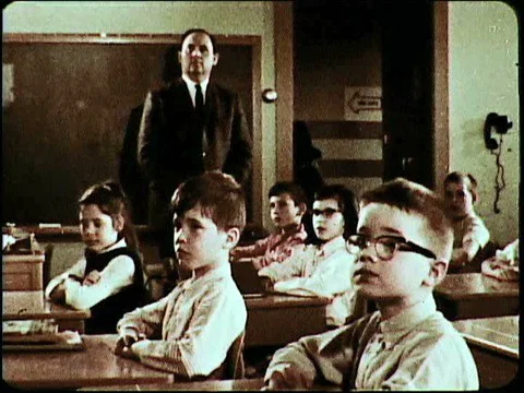 An elementary school teacher uses an animated film on volcanoes to engage his Stock Footage 74935951