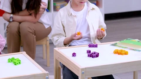 Elementary Student Counting Colorful Math Cubes in Classroom Activity Stock Footage 330102317