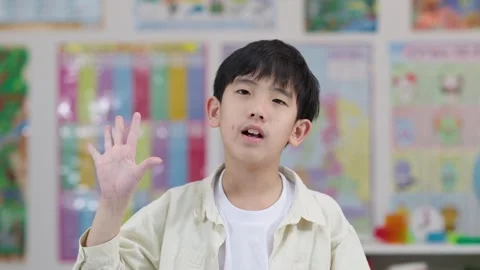Elementary Student Counting on Fingers in Classroom Setting Stock Footage 328083721