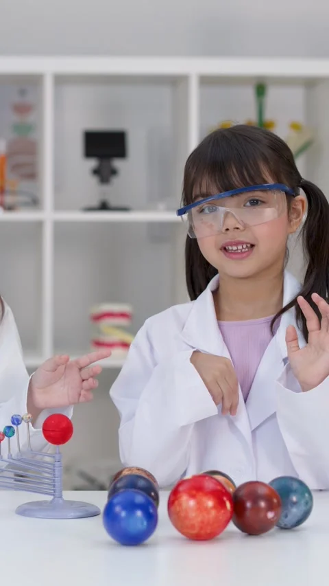 Elementary Student Explaining Solar System Model in School Science Laboratory 스톡 동영상 341375772