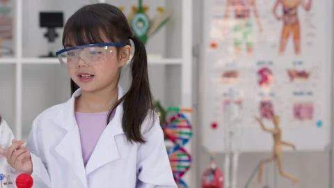 Elementary Student in Lab Coat Presenting Science Project in Classroom Stock Footage 346442645