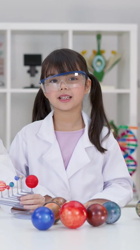 Elementary Student in Lab Coat Presenting Solar System Science Project Stock Footage 346442940