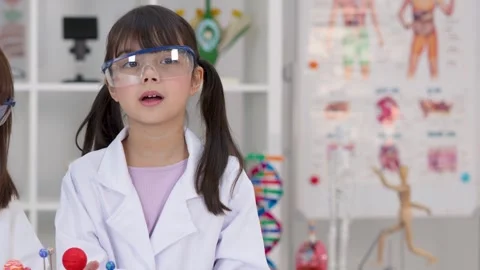 Elementary Student in Lab Coat Presenting Science Project in Classroom Stock Footage 346450066