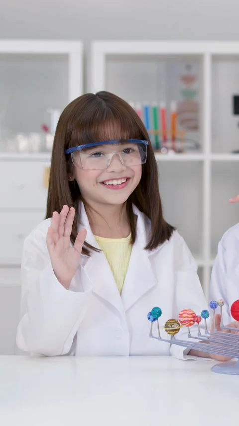 Elementary Student in Lab Coat Studying Solar System Model Stock Footage 341392977