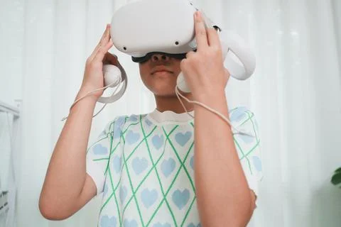 Elementary student learning with VR headset in classroom. Immersive edtech. Stock Photos