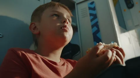 Elementary Student Taking Lunch Break While Eating Burger From Lunch Container Stock Footage 342027563