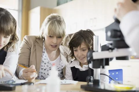 Elementary students and teacher in science classroom Stock Photos