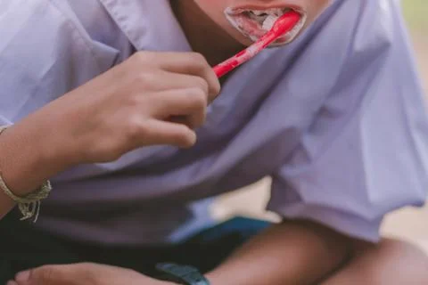 Elementary Students brush their teeth after lunch at school. Stock Photos