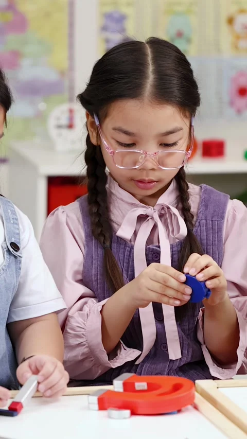 Elementary Students Exploring Magnetic Force During STEM Science Lesson Stock Footage 328346157