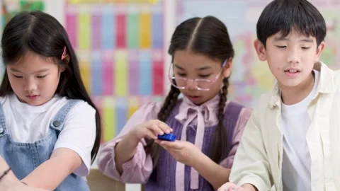 Elementary Students Exploring Magnets During Hands-On Science Activity Stock Footage 326748175
