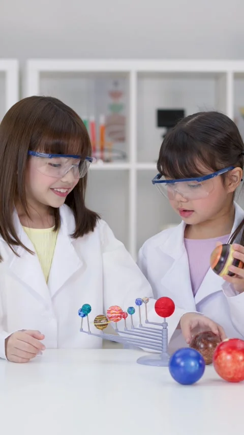 Elementary Students in Lab Coats Building Solar System Model Stock Footage 342686291