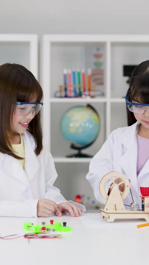Elementary Students in Lab Coats Building Wooden STEM Engineering Project Stock Footage 344941958