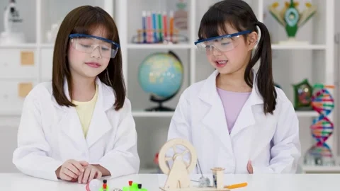 Elementary Students in Lab Coats Conducting Electronics Science Experiment Stock Footage 340118083