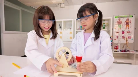 Elementary Students in Lab Coats Conducting Science Experiment Stock Footage 340244453