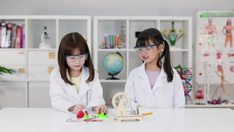 Elementary Students in Lab Coats Conducting Electronics Science Experiment Stock Footage 341917334