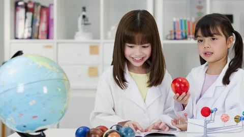 Elementary Students in Lab Coats Studying Solar System Model Stock Footage 341667698