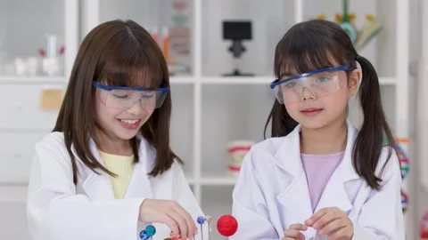 Elementary Students in Lab Coats Studying Solar System Model Stock Footage 341917378