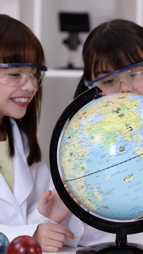 Elementary Students in Lab Coats Studying World Globe in Science Class Stock Footage 342090380
