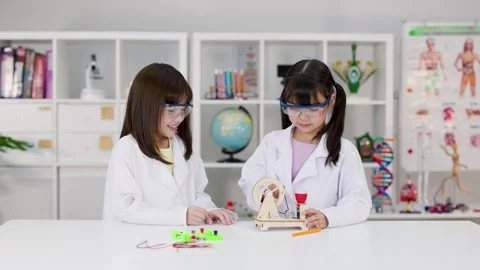 Elementary Students in Lab Coats Working on STEM Engineering Project Stock Footage 340009461