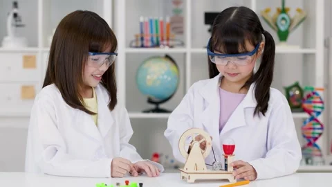Elementary Students in Lab Coats Working on STEM Engineering Project Stock Footage 340009541
