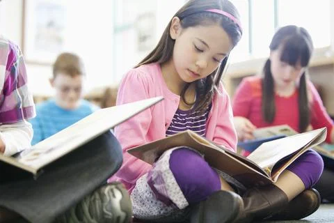 Elementary students reading in class Stock Photos